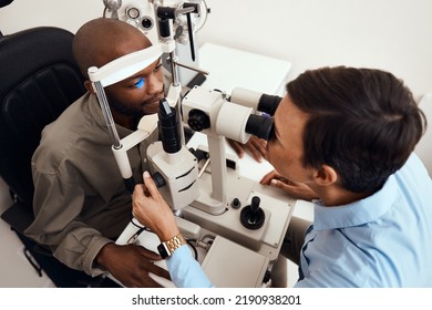 Eye, vision or sight test or exam of a patient above at an optometrist, optician or ophthalmologist. Testing and checking eyesight on a ophthalmoscope for optical glasses or contact lenses at clinic - Shutterstock ID 2190938201
