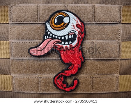 The Eyeball morale patch is a Velcro patch for attaching to clothing and bags.