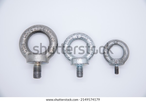Eyebolt for lifting. Lifting bolt for\
lifting work. Various measures, isolated on\
white.