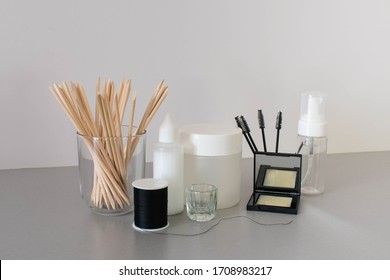 Eyebrow And Beauty Treatment Products In Neutral Colours Against A White Background.  Salon Equipment Includes Brow Threading, Wax, Tinting, Mascara Wands And Makeup Brushes.