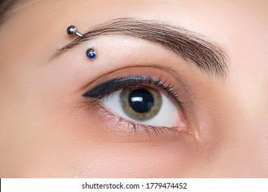 Eyebrow piercing. Eyelash tattoo. Cosmetic procedures.