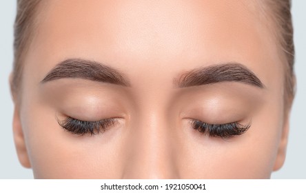 Eyebrows of a girl after plucking and cutting close-up. The make-up artist will do permanent eyebrow makeup. Makeup and cosmetology concept, eyebrow shape modeling.