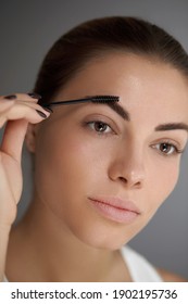 Eyebrows Shaping. Portrait Of Beautiful Girl With Brow Pencil. Close-up Of Young Woman With Professional Makeup Contouring Brows With Eyebrow Pencil. Beauty Cosmetic Concept. 