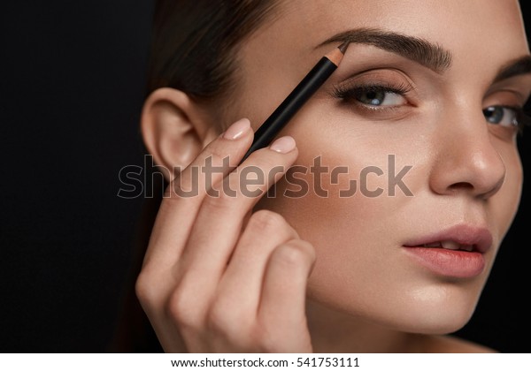 Eyebrows Shaping. Portrait Of Sexy Young Girl\
With Brow Pencil. Closeup Of Beautiful Glamourous Woman With\
Professional Makeup Contouring Brows With Eyebrow Pencil. Beauty\
Concept. High\
Resolution