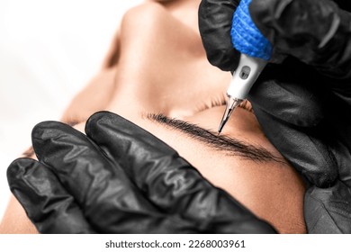 Eyebrows tattoo or Permanent Makeup. Detail of beautiful woman, eyebrow with nice black Brows In Beauty Salon. Beauty eyebrow upgrade procedure. - Shutterstock ID 2268003961