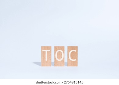 Eye-catching image of TOC text on wood blocks. The word stands for Theory Of Constraints.