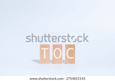 Eye-catching image of TOC text on wood blocks. The word stands for Theory Of Constraints.