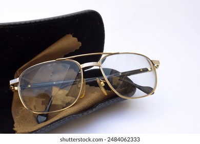 An eyeglass photo on White Background with its case. A shot of glasses placed on a white background with its case, useful for illustrating a clean and minimalist setting. - Powered by Shutterstock