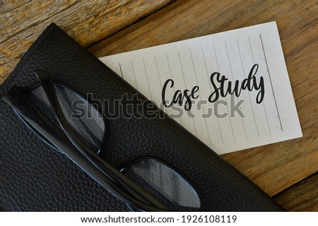 Eyeglasses, black file and white paper written with CASE STUDY