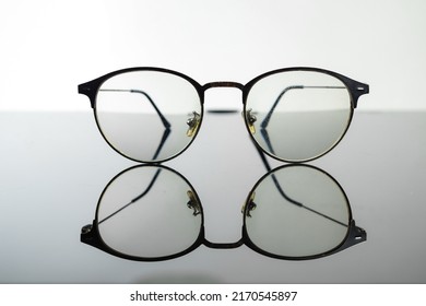 Eyeglasses with black frame on white background. Eye glasses. Round glasses with transparent lenses. Close up eyeglasses with blurry technique. Fashion accessory. Ophthalmology theme. - Shutterstock ID 2170545897