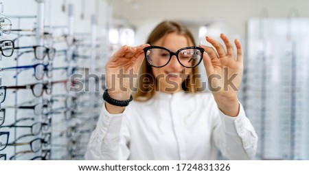 Eyeglasses closeup. Spectacles in woman's hands. Presenting glasses. Zoom in