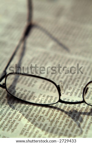 eyeglasses lying on a (german) newspaper, shallow DoF