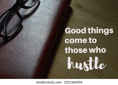 Eyeglasses and notebook over wooden background written with GOOD THINGS COME TO THOSE WHO HUSTLE. - Powered by Shutterstock