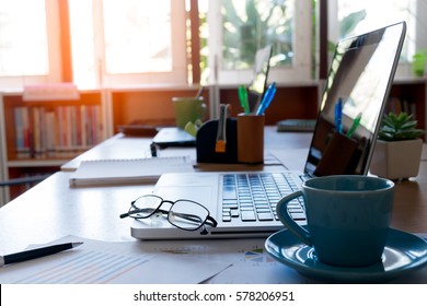 Eyeglasses on laptop keyboard with blue coffee cup and diary on wooden table
 - Powered by Shutterstock - Get 15% off with code: PIKWIZARD15