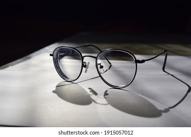 eyeglasses with eyeglasses shadow on papper