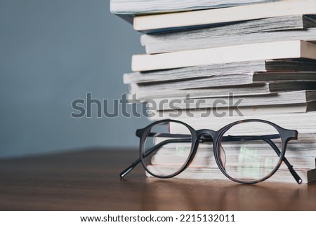 Eyeglasses and a stack of books