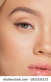 Eyelash extension procedure. Beautiful female eyes with long lashes closeup.