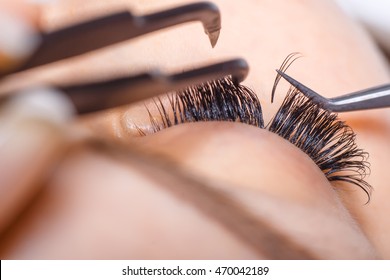 Eyelash Extension Procedure. Woman Eye with Long Eyelashes. Lashes, close up, macro, selective focus. - Shutterstock ID 470042189