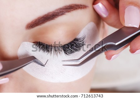 Eyelash Extension Procedure. Woman Eye with Long Eyelashes. Lashes, close up, macro, selective focus. Foto stock © 