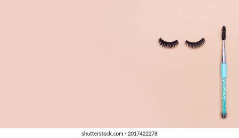 Eyelash Extensions And Lash Brush On Light Brown Background. Eyelash Artist Marketing Materials.