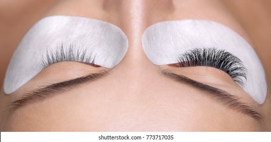 Eyelash removal procedure close up. Beautiful Woman with long lashes in a beauty salon. Eyelash extension. - Shutterstock ID 773717035