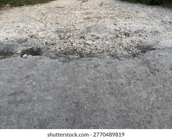 An eye-level perspective shot looking down a worn, unpaved trail