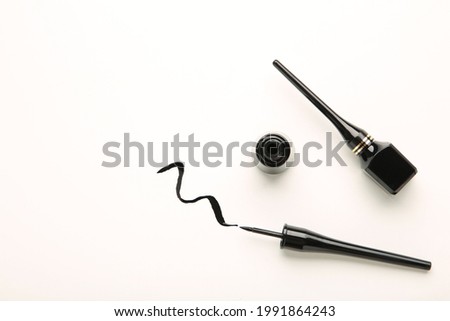 Eyeliners and stroke on white background with copy space.