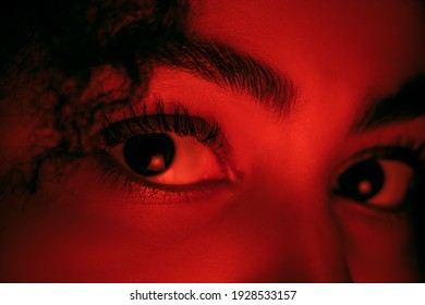 Eyes Close Up. Beautiful African-american Woman's Portrait Isolated On Red Studio Background In Neon, Monochrome. Concept Of Human Emotions, Facial Expression, Sales, Ad, Fashion And Beauty.