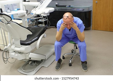 Eyes problem.Tired mature dentist having short break for regeneration after long working hours in his office