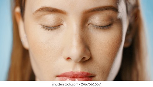 Eyeshadow, beauty and face of woman in studio for makeup, cosmetics or glamour on blue background. Closeup, salon and model with eyes closed for foundation, glowing skin or aesthetic transformation - Powered by Shutterstock