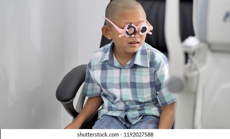 Eyesight Check. Asian Boys Who Have Vision Disabilities. Left Eye Is Not Visible From Brain Surgery. Medical Treatment And Rehabilitation