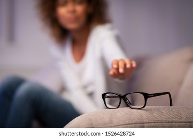 Eyesight Problem. Woman Reaching For Eyeglasses On Sofa, Having Poor Eye Sight