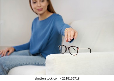 Eyesight Problem. Woman Reaching For Eyeglasses On Sofa, Having Poor Eye Sight. Selective Focus.