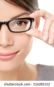 Eyewear glasses woman closeup portrait. Woman wearing glasses holding frame in close-up. Beautiful young mixed race Caucasian / Asian Chinese female model on white background.