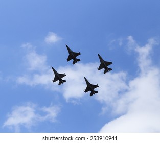 f16 falcon fighter jet flying on blue sky background