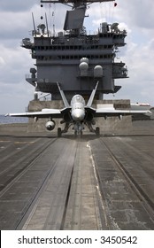 An F-18 Hornet Sits Ready On A Catapult On Board An Aircraft Carrier