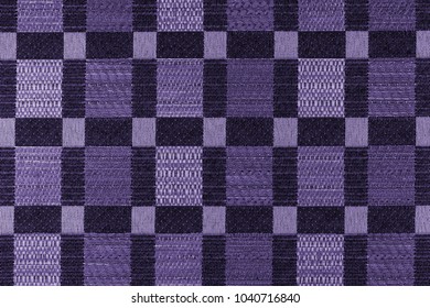 Fabric with a background with geometric patterns. Close-up. (photo is toned in ultra violet)