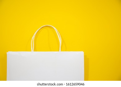 Fabric bag or bags made from paper and things made from natural materials with yellow background Ideas for reducing plastic bags - Shutterstock ID 1612659046