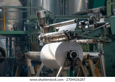Fabric batching process machine industrial plant line in a textile factory.