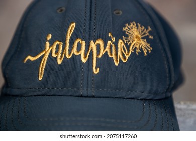 Fabric Cap In Dark Green Tone With The Name Jalapão Embroidered With Thread In Golden Color.