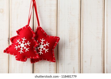 Fabric Christmas ornament hanging on wooden background - Powered by Shutterstock