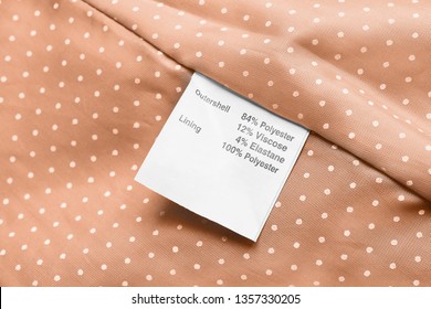 Fabric Composition Clothes Label On Beige Textile Background