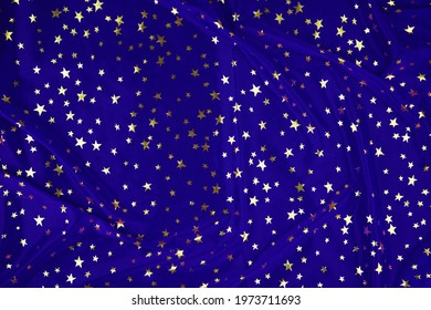 Fabric Drapery Backdrop Abstract Background. Royal Blue Silk, Satin With Golden Stars. Shapeless Empty Surface. Сopy Space For Design