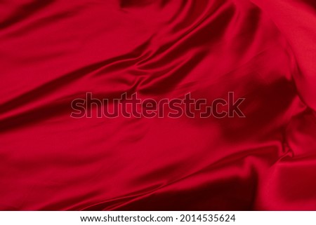 Fabric drapery backdrop abstract background. Red silk, satin. Shapeless empty surface. Сopy space for design