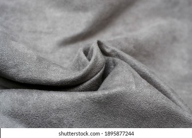Fabric is grey suede. The texture is faux suede . Background of a suede curtain.