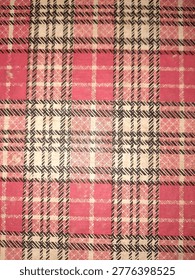 A fabric or printed surface displaying a bold plaid pattern composed of intersecting lines in red, black, and off-white, forming distinct square and rectangular blocks.