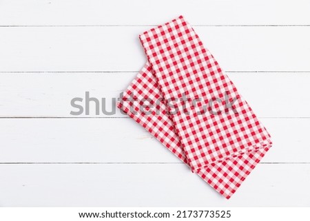 Fabric red and white tablecloth checkered on white the wood background. Top view, Flat lay cotton checkered with copy space.