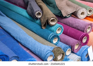 Fabric Rolls Of Blue And Purple Flax Linen And Canvas Textile Background. Old Carton Reels With Colorful Material On A Retail Market Stall, Close Up, High Angle View