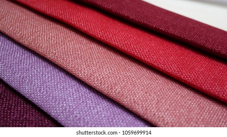 Fabric Samples Of Different Colors In Move Are Spinning And Rotation: Turquoise, Blue, Purple, Pink, Red. Textile Textures Fabric Swatches