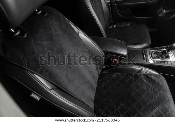 fabric seat cover\
in a car in a black\
interior